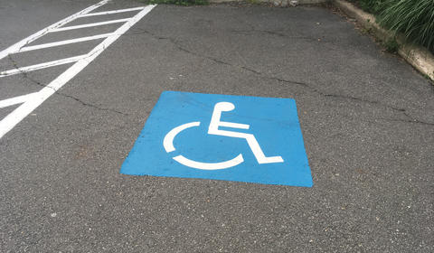 Handicap Space with blue painted marker on the ground