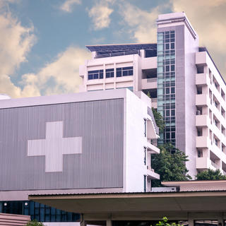 Concrete hospital building with medical cross