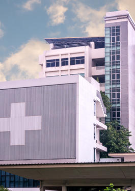 Concrete hospital building with medical cross