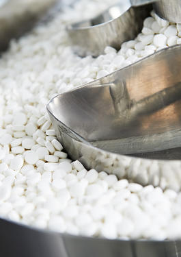 White pills in a metal machine