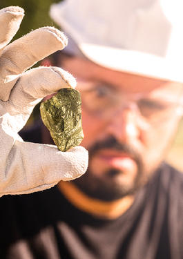 Miner examining a nugget of gold