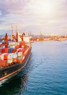 Colorful cargo ship sailing away from dock