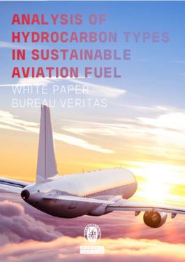 Airplane flying through sky at sunrise 