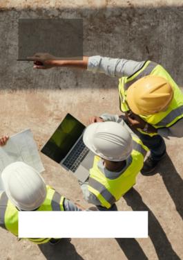 3 auditors reviewing plans and a laptop