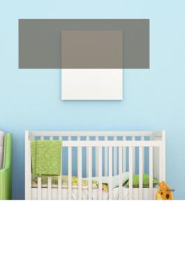 baby's room with a white crib, green chair, and giraffe riding toy