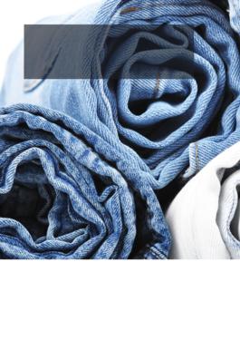 different colored jeans rolled up and stacked