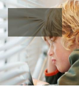 child looking out closed window blinds
