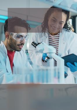 two scientists looking at a microscope