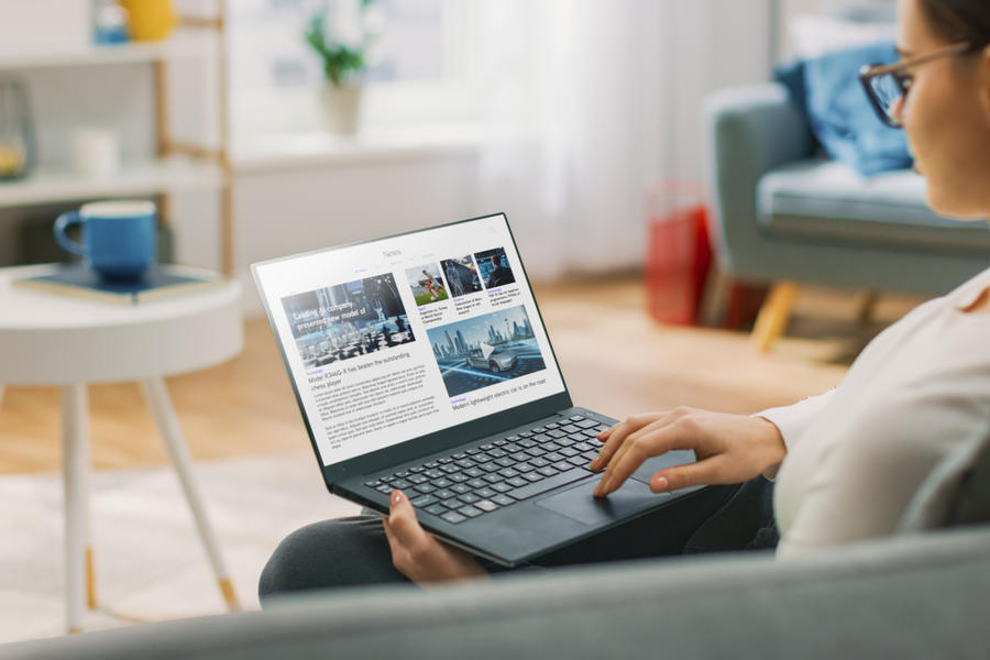 Person Reading Technical Paper Article On Laptop