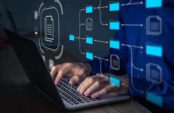 person working on computer with folder flowchart