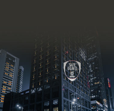 Street view of a skyscraper at night with Bureau Veritas SafeGuard label