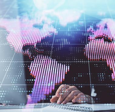 digitized world map projected over a person working at a desk